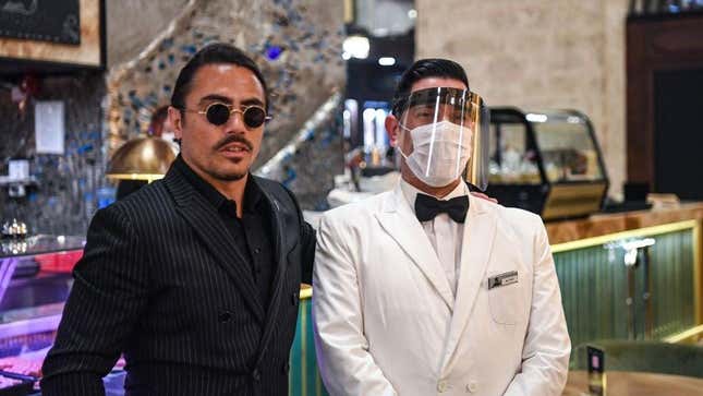 Salt Bae poses with waiter at steakhouse