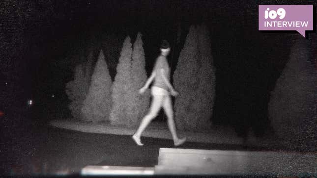  A blurry image of a young woman walking in the dark