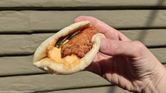 Hand holding Taco Bell Crispy Chicken Sandwich Taco 