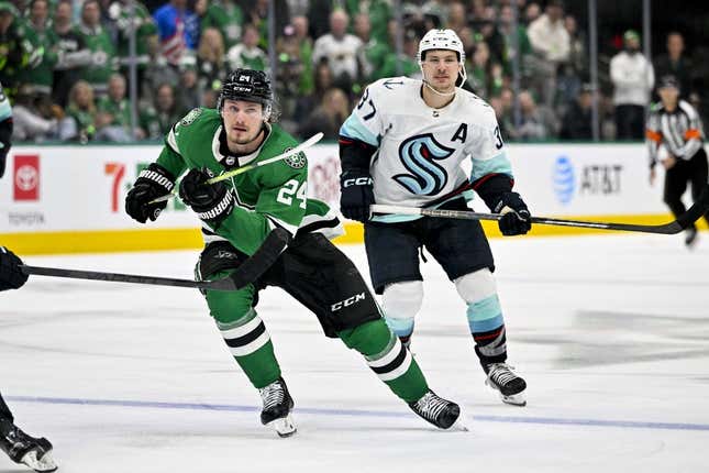 May 2, 2023; Dallas, Texas, USA; Dallas Stars center Roope Hintz (24) and Seattle Kraken center Yanni Gourde (37) chase the puck during the overtime period in game one of the second round of the 2023 Stanley Cup Playoffs at the American Airlines Center.