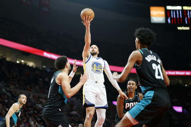 Apr 9, 2023; Portland, Oregon, USA; Golden State Warriors point guard Stephen Curry (30) shoots the ball against Portland Trail Blazers guard Skylar Mays (8, left) and  forward John Butler Jr. (21) during the first half at Moda Center.
