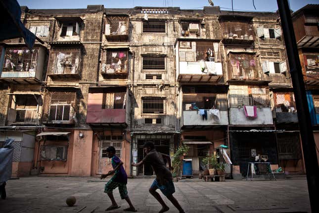 The courtyard of the BDD chawl. Constructed in 1922 as jails, the chawls eventually became homes for the mill workers. As the years went on, families grew and residents tried to expand to make more room (the white and red makeshift balconies in the picture for example).