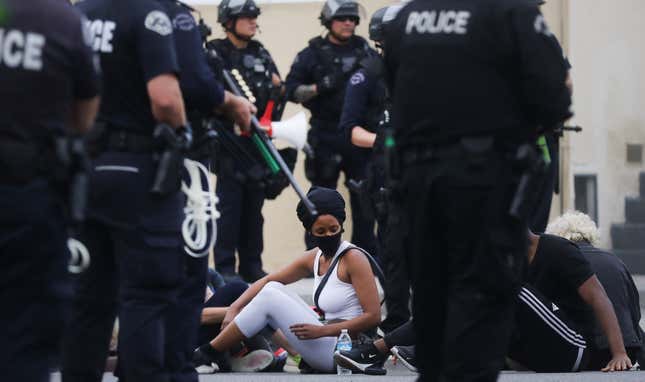Protesters are detained by police before being arrested for a curfew violation in the Hollywood area while peacefully demonstrating over George Floyd’s death on June 1, 2020, in Los Angeles.