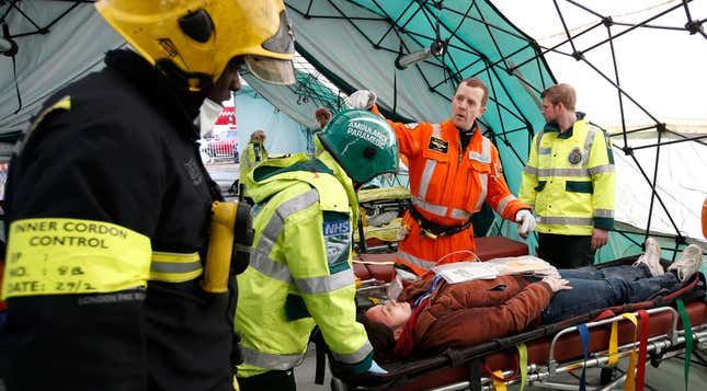 A paramedic works on a simulated casualty.