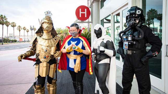Cosplayers Christopher Canole as Dude Vader, Faeren Adams as Dr. Strange, Derek Shackelton as Moon Knight, and Todd Felton as a TIE Pilot pose in front of Hall H at San Diego Convention Center on July 22, 2020 in San Diego, California. 