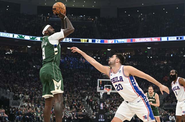 Mar 4, 2023; Milwaukee, Wisconsin, USA; Milwaukee Bucks forward Bobby Portis (9) shoots the ball against Philadelphia 76ers forward Georges Niang (20) in the first half at Fiserv Forum.