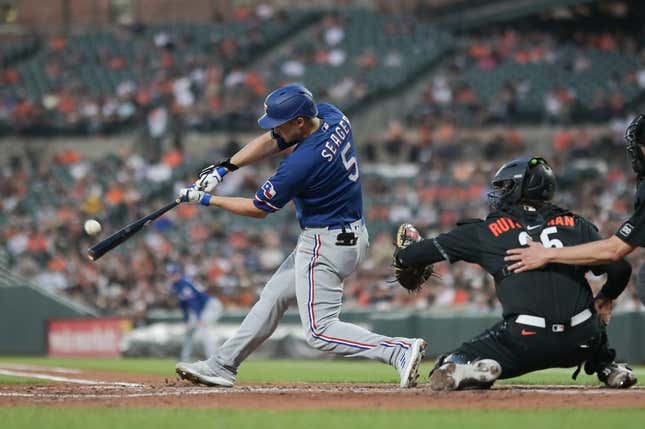 May 26, 2023; Baltimore, Maryland, USA;  Texas Rangers shortstop Corey Seager (5) hits a fourth inning grand slam off Baltimore Orioles starting pitcher Grayson Rodriguez (30) at Oriole Park at Camden Yards.