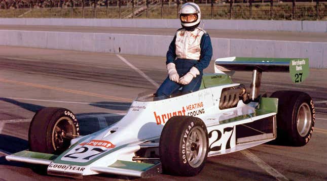 Janet Guthrie poses with an Indy car at Ontario Motor Speedway, 1977