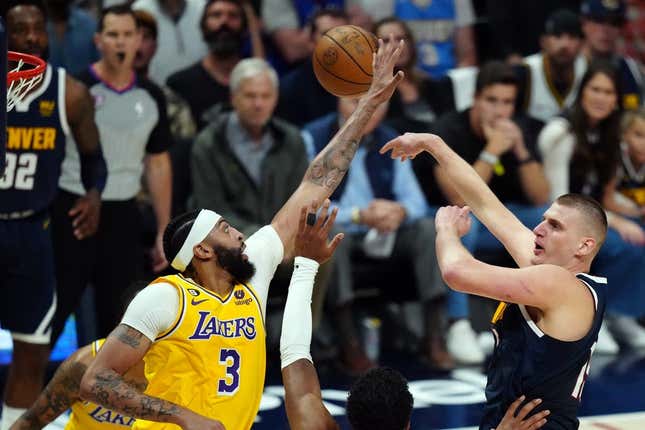 May 18, 2023; Denver, Colorado, USA; Denver Nuggets center Nikola Jokic (15) shoots against Los Angeles Lakers forward Anthony Davis (3) in the first half during game two of the Western Conference Finals for the 2023 NBA playoffs at Ball Arena.