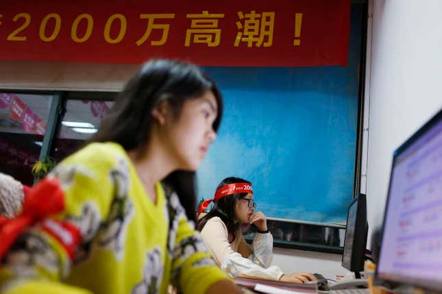 Employees of a Tmall, which sells underwear on Alibaba, work online to serve customers and deal with orders overnight in Hangzhou, early November 11, 2014. Alibaba Group Holding Ltd said about $2 billion worth of goods were sold on the e-commerce giant's websites within the first hour and 12 seconds of its annual shopping festival. REUTERS/Aly Song (CHINA - Tags: BUSINESS EMPLOYMENT) - RTR4DNI3