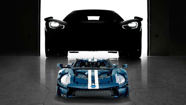 A photo of a Lego Ford GT in front of a full-size car. 