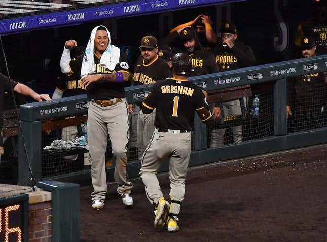 Jul 31, 2023; Denver, Colorado, USA; San Diego Padres third baseman Manny Machado (13) comes out of the dugout to greet center fielder Trent Grisham (1) after hitting a home run in the ninth inning to tie the game against the Colorado Rockies at Coors Field.