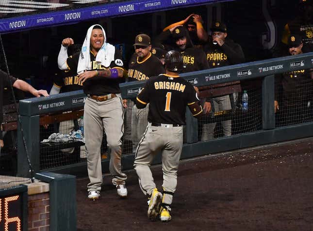 San Diego Padres' Manny Machado, center, talks with Cincinnati