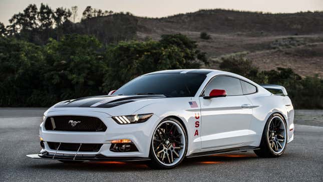A photo of a white Ford Mustang with USA badges. 