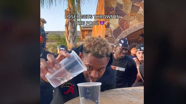 Juju Smith-Schuster pours water into a plastic cup.