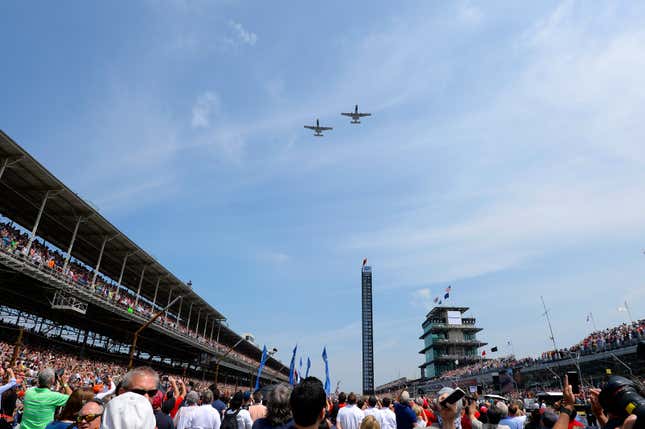 Military planes fly over the Indianapolis Motor Speedway during pre-race ceremonies for the 2015 Indy 500