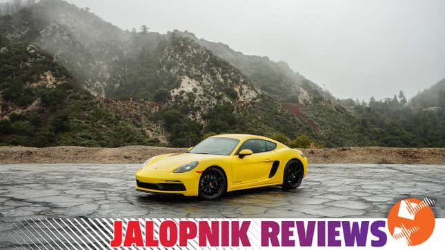 A wide three-quarter view of the 2023 Porsche Cayman GTS 4.0 with a jalopnik reviews banner at the bottom of the image