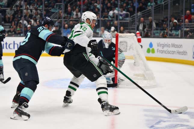 May 9, 2023; Seattle, Washington, USA; Dallas Stars center Radek Faksa (12) plays the puck while guarded by Seattle Kraken defenseman Vince Dunn (29) during the first period in game four of the second round of the 2023 Stanley Cup Playoffs at Climate Pledge Arena.