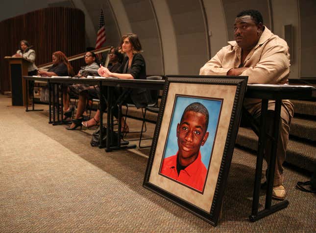 Andrew Joseph Jr. sits behind a picture of his deceased son, Andrew Joseph III, at a Black Lives Matter forum at John Germany Library in Tampa, Fla., on Wednesday, Sept. 9, 2015. A Florida sheriff has been ordered by a jury to pay $15 million to the parents of Andrew Joseph III, a teenager who died while trying to cross a highway after being kicked out of the state fair by deputies. The 10-person jury reached its verdict Thursday, Sept. 22, 2022.