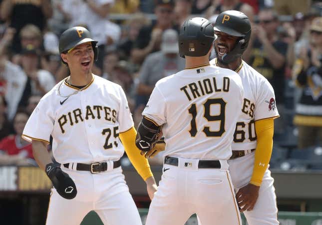 Aug 13, 2023; Pittsburgh, Pennsylvania, USA; Pittsburgh Pirates catcher Endy Rodriguez (25) and shortstop Liover Peguero (60) congratulate pinch hitter Jared Triolo (19) at home plate after Triolo hit a three run home run to record his first major league home run against the Cincinnati Reds during the seventh inning at PNC Park.