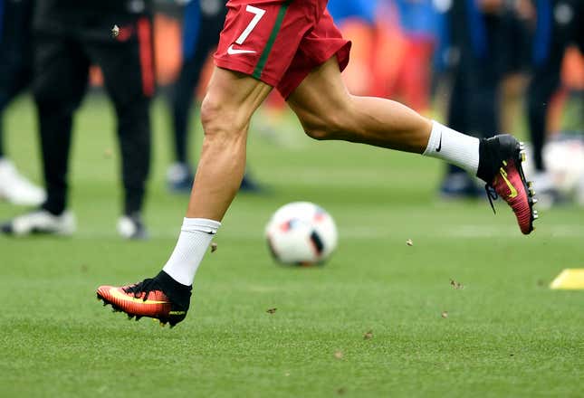 Moths fly around as Portugal's Cristiano Ronaldo runs during warm up before the Euro 2016 final soccer match between Portugal and France at the Stade de France in Saint-Denis, north of Paris, Sunday, July 10, 2016. (AP Photo/Martin Meissner)