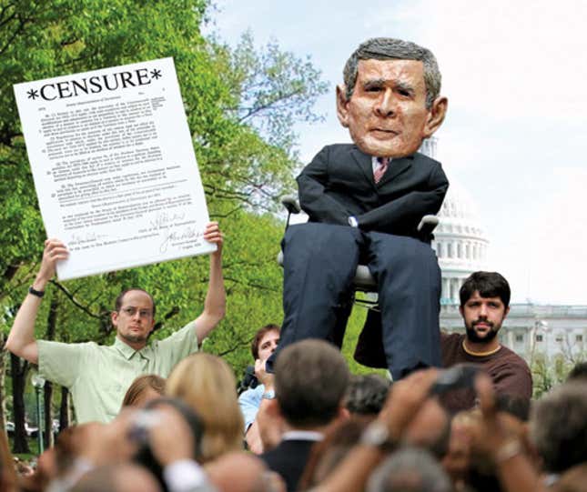 An activist holds aloft the censure motion so that all in the crowd can read it carefully and make up their minds.