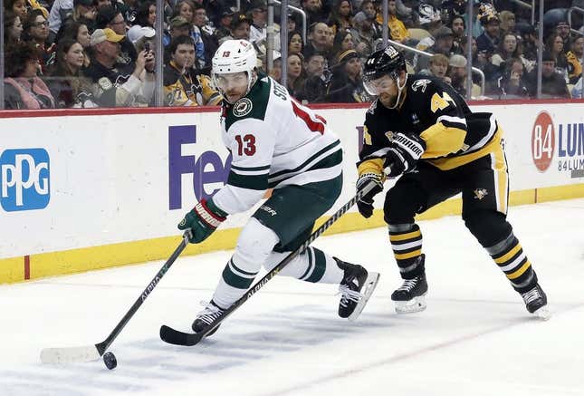 Apr 6, 2023; Pittsburgh, Pennsylvania, USA; Minnesota Wild center Sam Steel (13) moves the puck against Pittsburgh Penguins defenseman Jan Rutta (44) during the third period at PPG Paints Arena. Pittsburgh won 4-1.
