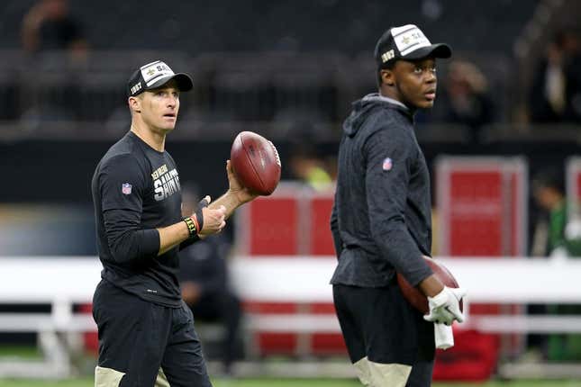 (File photo) New Orleans Saints quarterback Drew Brees (9) warms up before their game against the Arizona Cardinals at the Mercedes-Benz Superdome. Quarterback Teddy Bridgewater, right, looks on.
