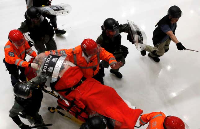 Emergency workers evacuate a person from Shatin’s New Town Plaza mall after police tried to disperse protesters, Hong Kong, July 14, 2019.