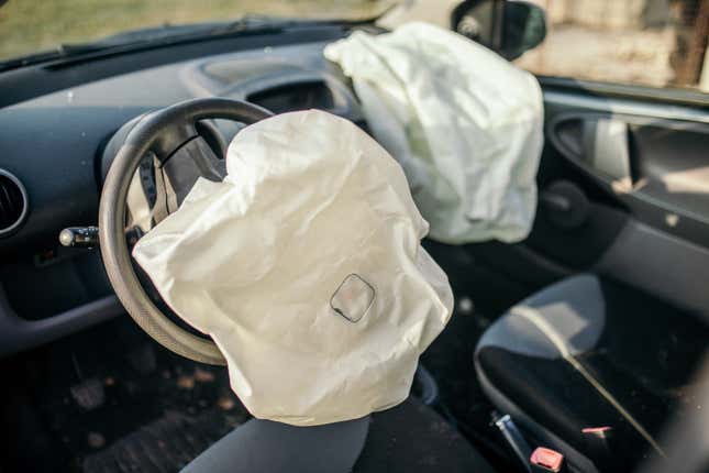 A car interior with multiple airbags deployed.