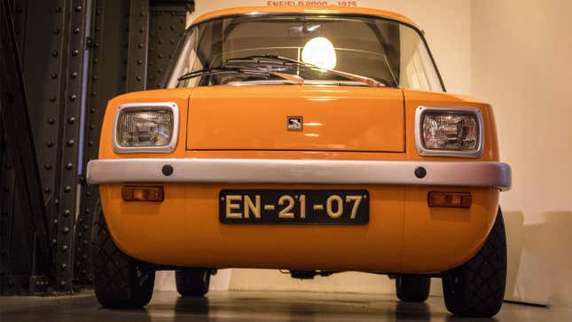 A photo of an orange Enfield electric car. 