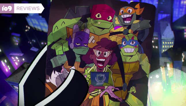 A hand holds up a photo of April O'Neill, Leo, Mikey, Donnie, and Raph as they appeared in Rise of the Teenage Mutant Ninja Turtles.