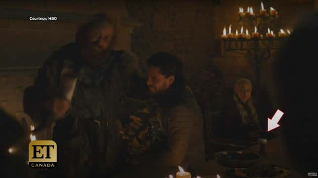 A scene from Game of Thrones in which a coffee cup is visible in the background