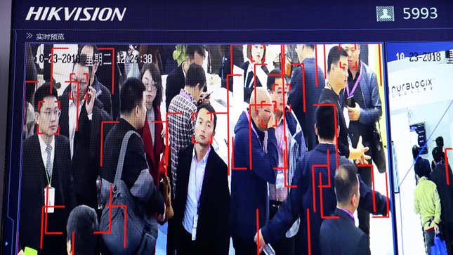 In this photo taken Tuesday, Oct. 23, 2018, visitors are tracked by facial recognition technology from state-owned surveillance equipment manufacturer Hikvision at the Security China 2018 expo in Beijing, China.