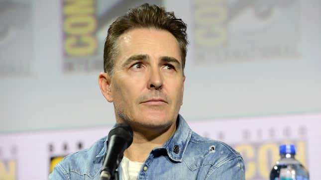 Nolan North sits on a panel at Comic-Con. 