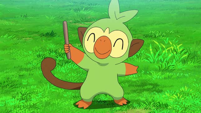 Grookey is seen standing on grass and holding up a drumstick while smiling.