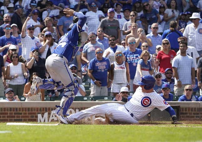 Aug 19, 2023; Chicago, Illinois, USA; Chicago Cubs catcher Yan Gomes (15) is safe at home plate as Kansas City Royals catcher Freddy Fermin (34) takes the throw during the fourth inning at Wrigley Field.