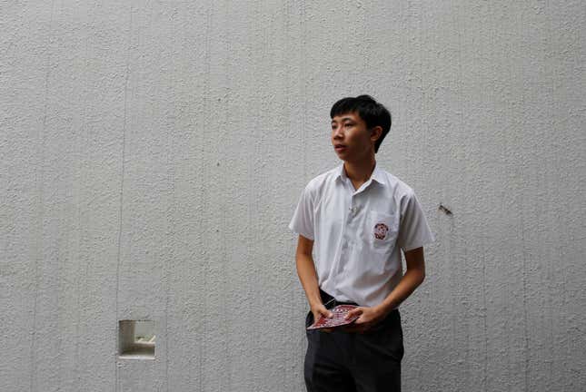Secondary school student Parco Wong Lok-hang, 17, hands out leaflets in school to promote Hong Kong independence, September 1, 2016.
