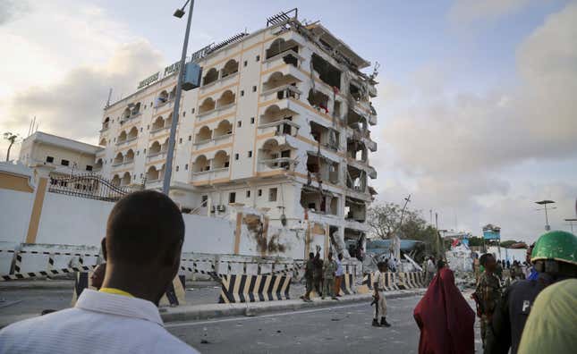 Somalis observe the destruction of Jazeera Palace Hotel following a suicide car bomb attack in the capital Mogadishu.