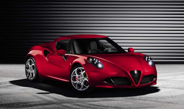 Red Alfa Romeo 4C on concrete with an aluminum/steel accordion-patterened garage door as a background. 