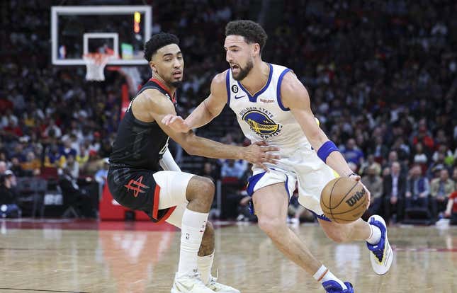 Mar 20, 2023; Houston, Texas, USA; Golden State Warriors guard Klay Thompson (11) drives with the ball as Houston Rockets forward KJ Martin (6) defends during the second quarter at Toyota Center.