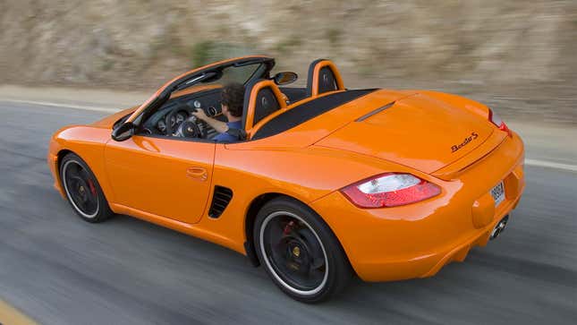 A photo of an orange Porsche Boxster S sports car. 