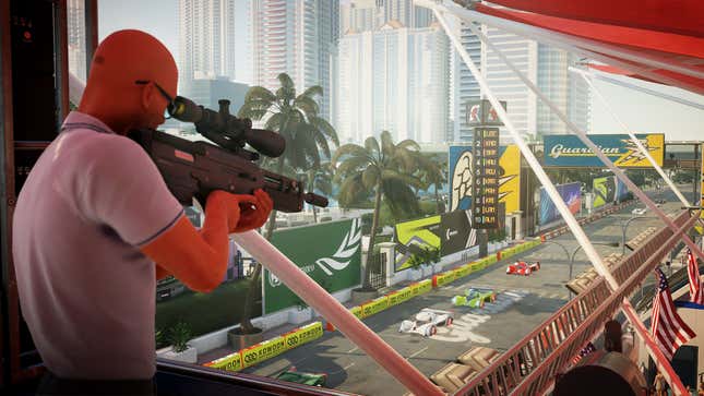 Agent 47 wields a sniper rifle from a balcony above a race track in Miami in Hitman 2.