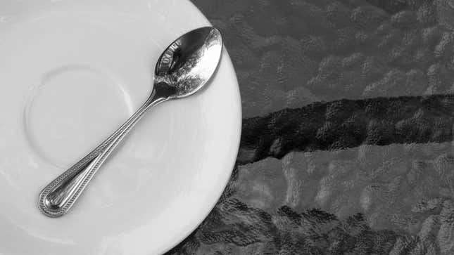 Spoon and saucer on outdoor table
