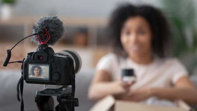 A camera takes a video of a young black woman 