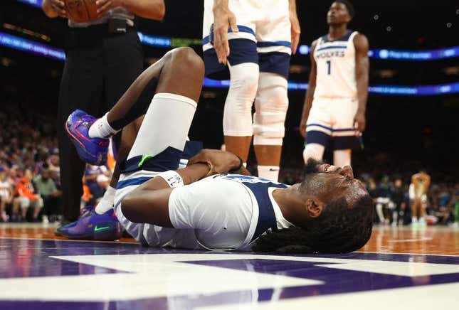 Mar 29, 2023; Phoenix, Arizona, USA; Minnesota Timberwolves center Naz Reid (11) reacts after suffering an injury against the Phoenix Suns in the second half at Footprint Center.