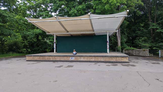 A teeny seven-year-old sits entirely alone on a dilapidated bandstand during the peak of Go Fest 2022.