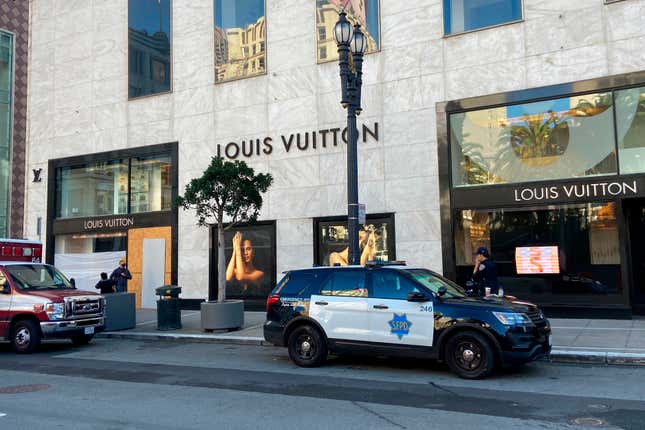 FILE - Police officers and emergency crews park outside the Louis Vuitton store in San Francisco&#39;s Union Square on Nov. 21, 2021, after looters ransacked businesses. California is making an unprecedented investment of more than $265 million in efforts to combat smash-and-grabs. (Danielle Echeverria/San Francisco Chronicle via AP, File)