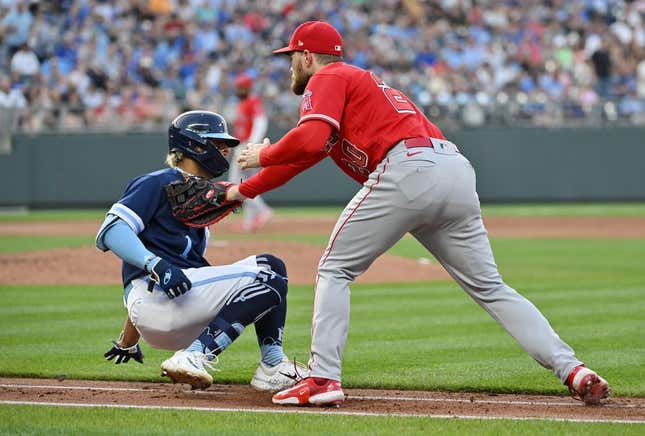 Jun 16, 2023; Kansas City, Missouri, USA; Los Angeles Angels first baseman Jared Walsh (20) tags out Kansas City Royals right fielder MJ Melendez (1) on the first baseline in the third inning at Kauffman Stadium.