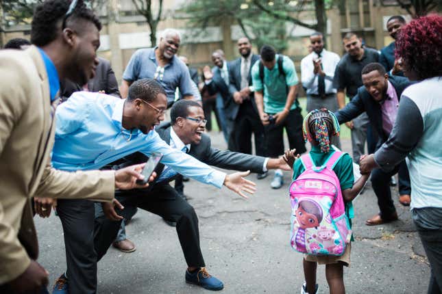 Image for article titled Why 100 impeccably dressed black men welcomed these kids to school
